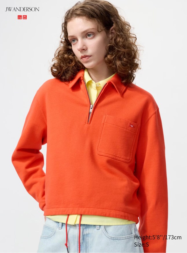Female wears orange quarter zip jumper